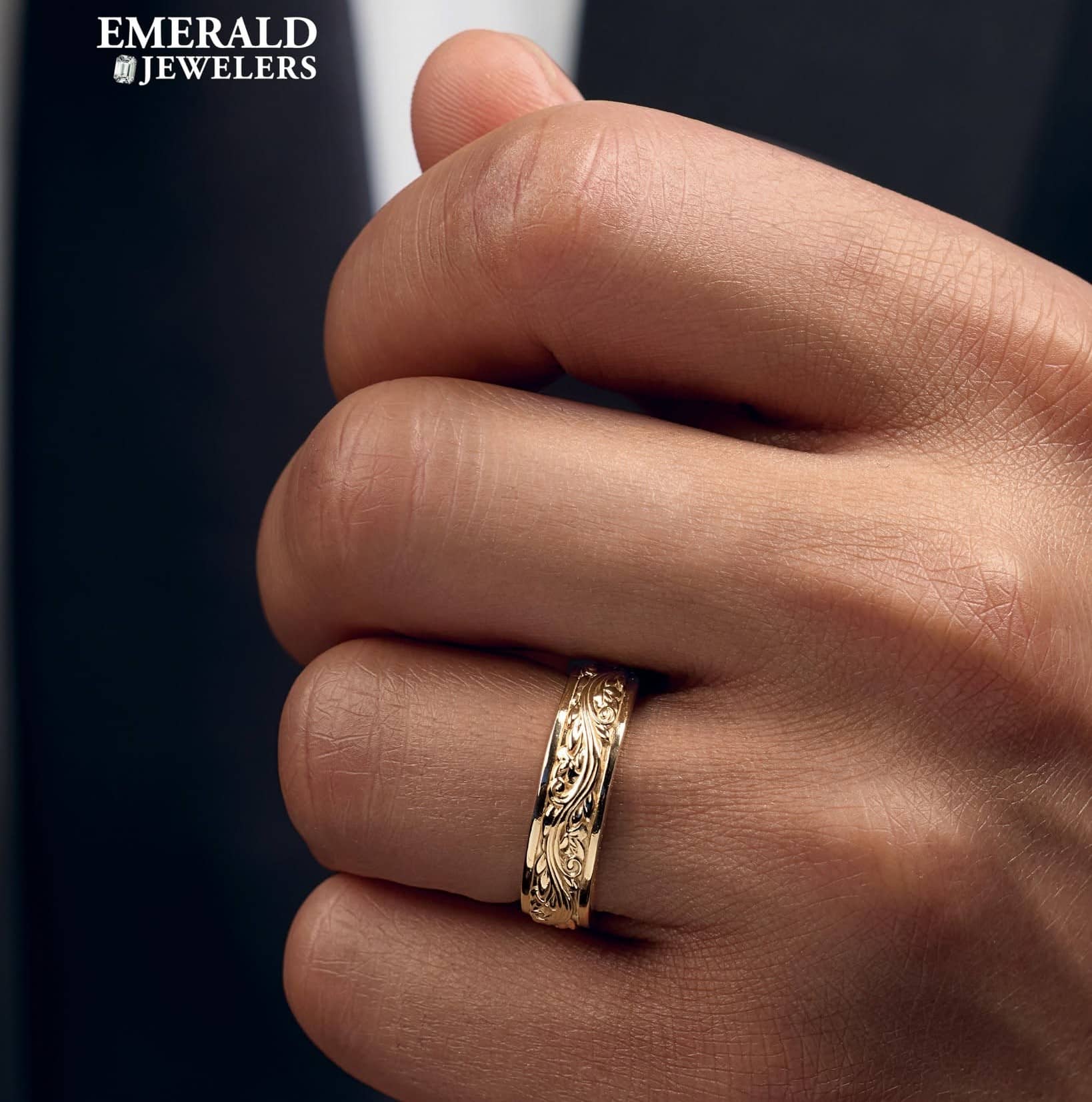 jeweler checking a customer’s finger with a ring sizer at Emerald Jewelers in Salem, NH